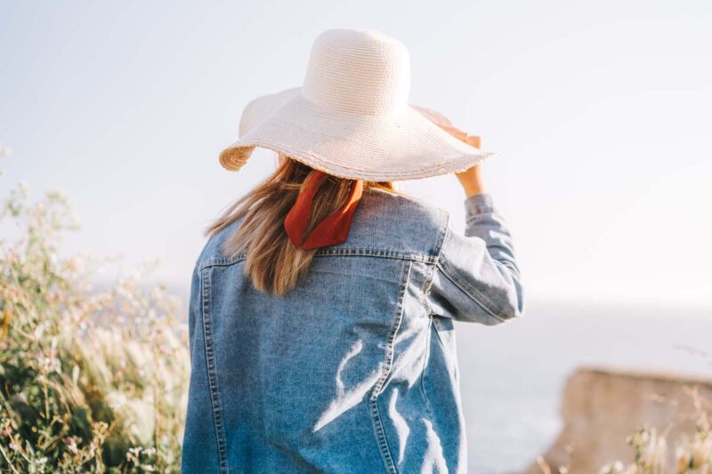 Women wearing hat under sunlight.