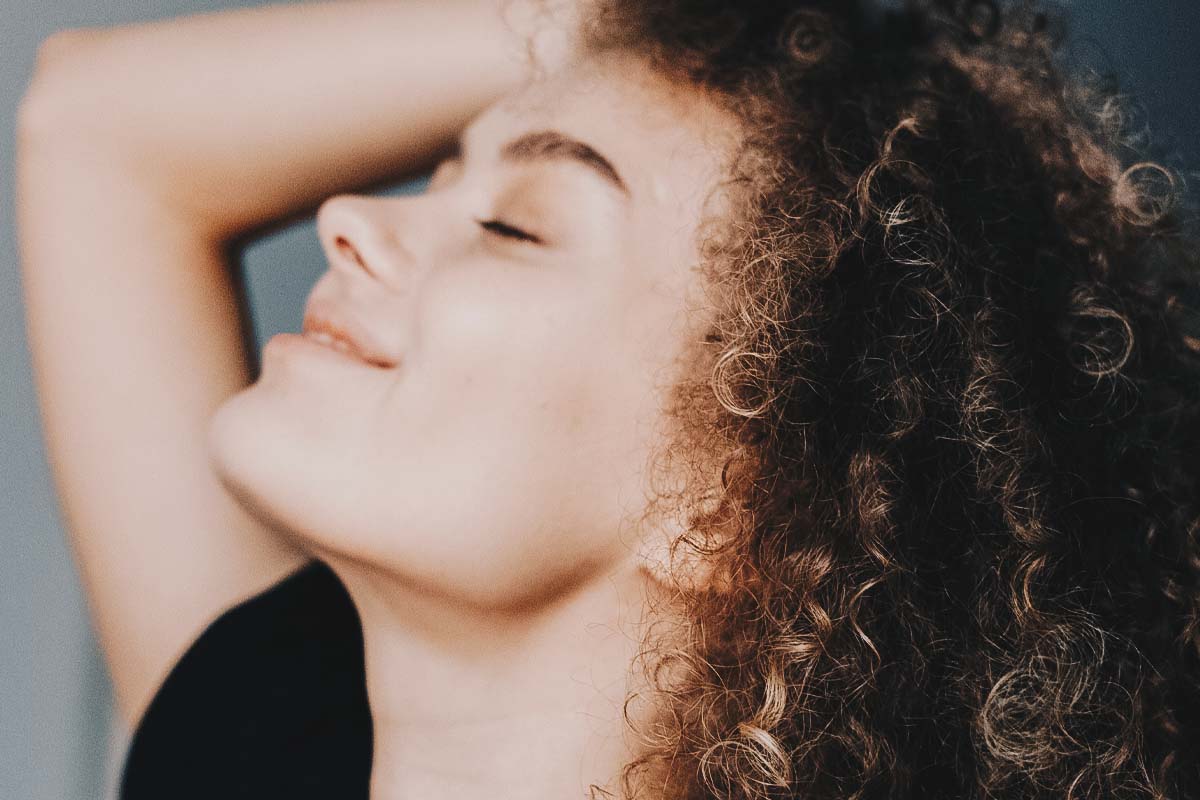 Woman smiling with eyes closed.